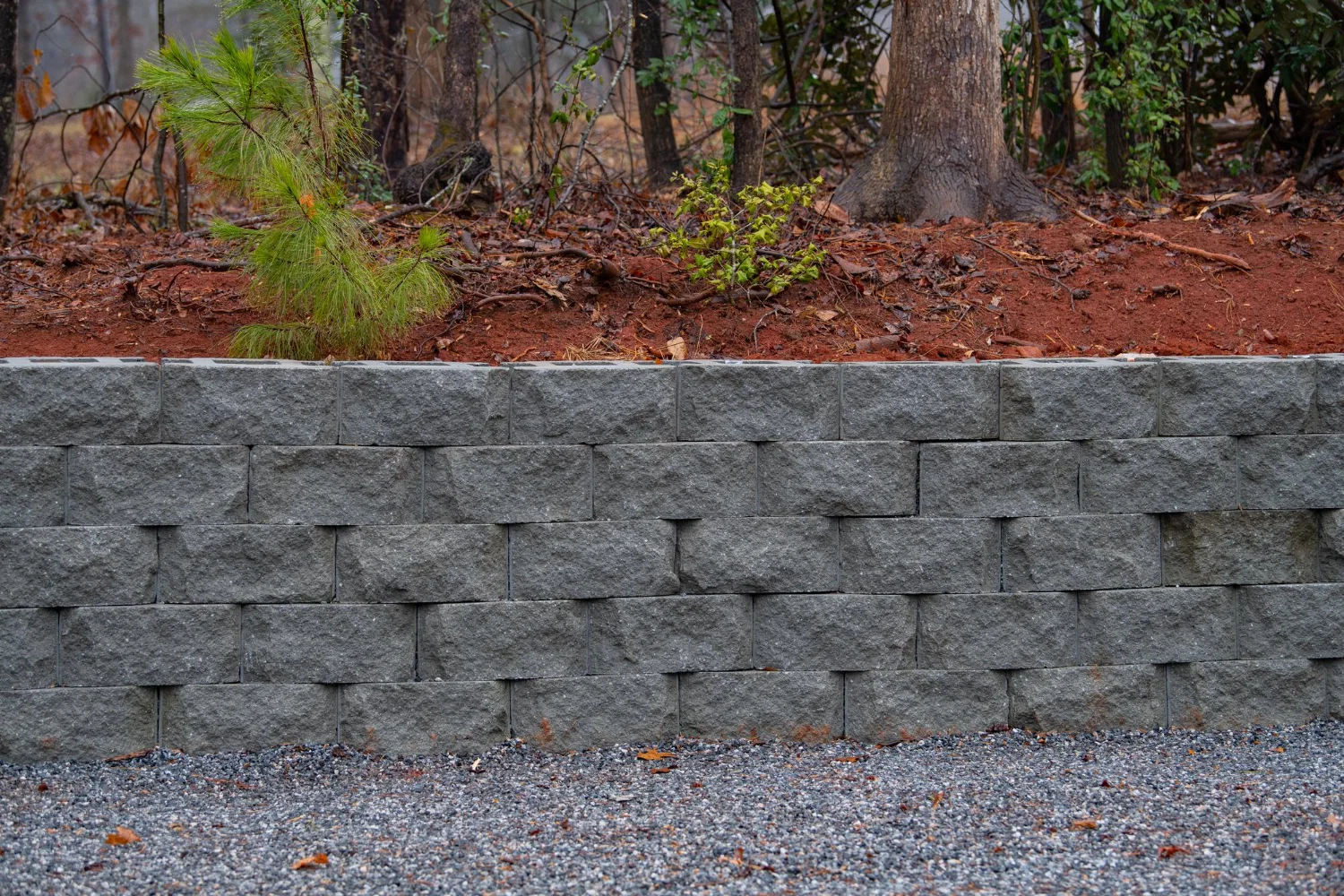 Professional retaining wall installation with stacked stone blocks in Richmond California backyard